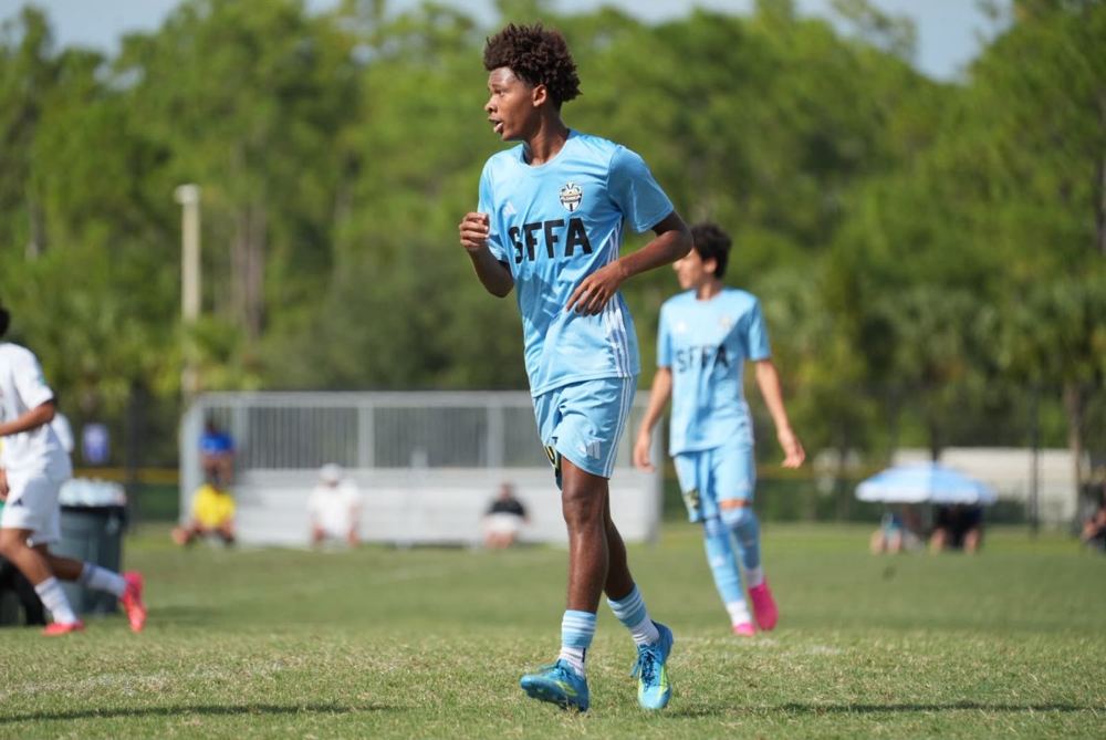Chaz L. Grey running forward in a light blue kit