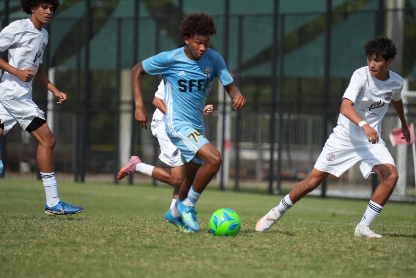 Chaz L. Grey dribbling forward toward the camera in his light blue SFFA kit