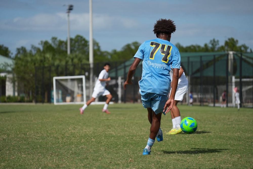 Chaz L. Grey, #74, dribbling upfield